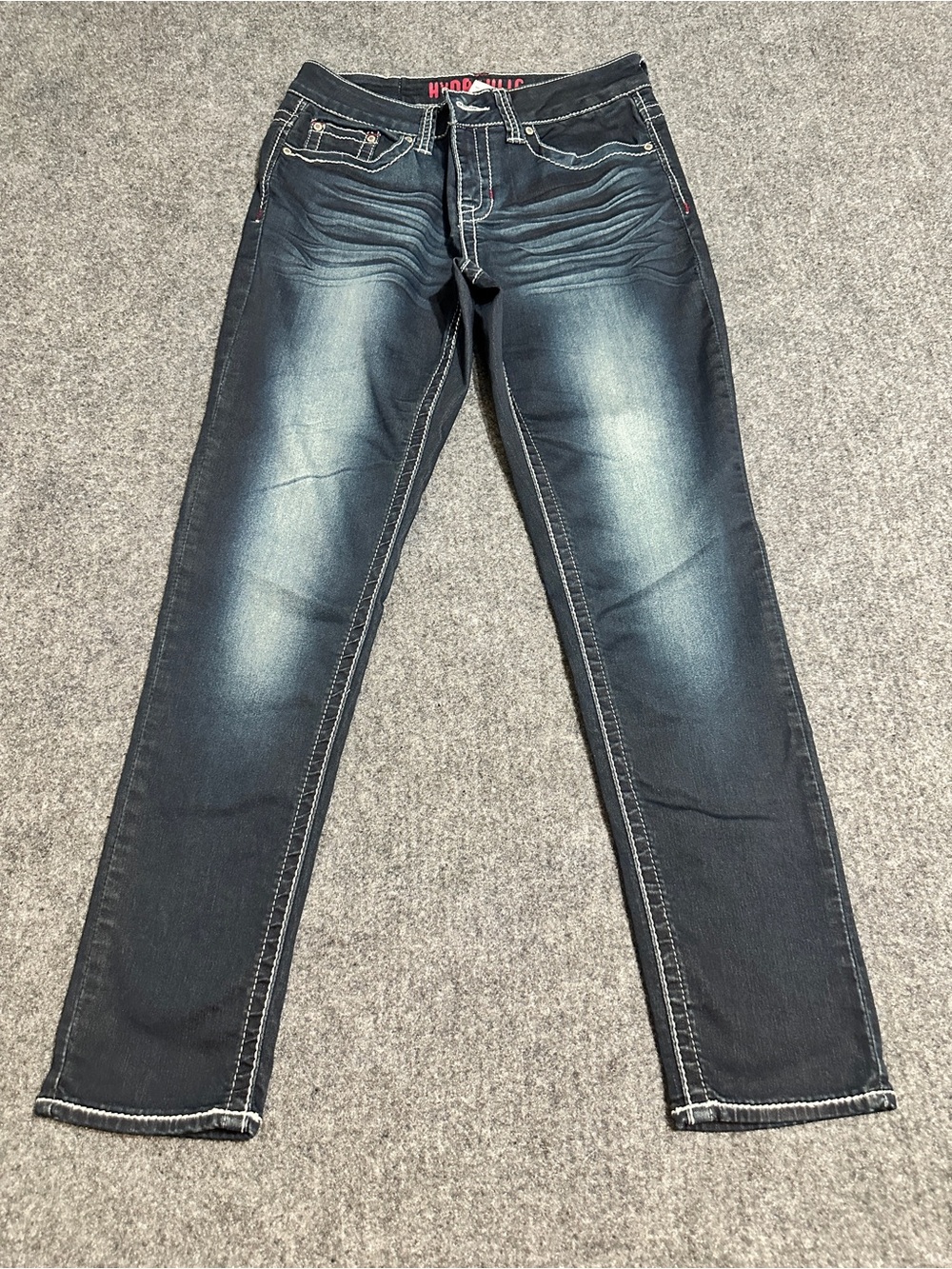Hydraulic jeans feature a dark wash denim finish